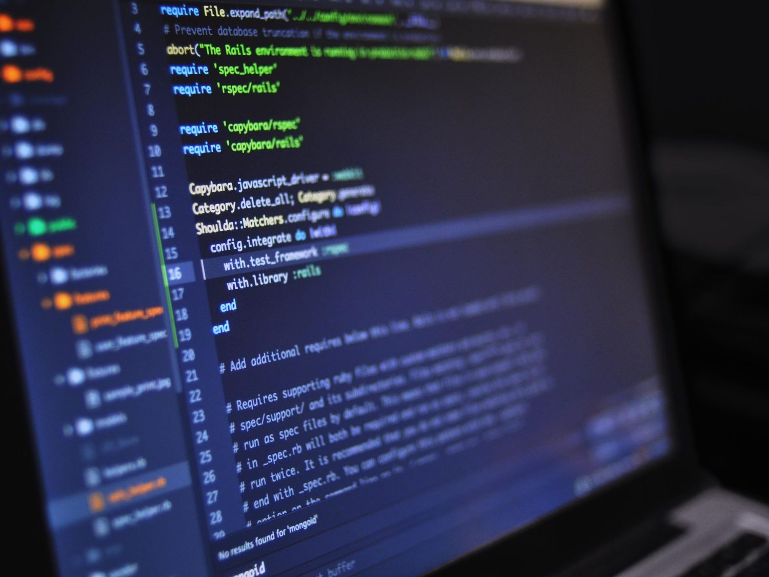 Website code open in an editor on a laptop